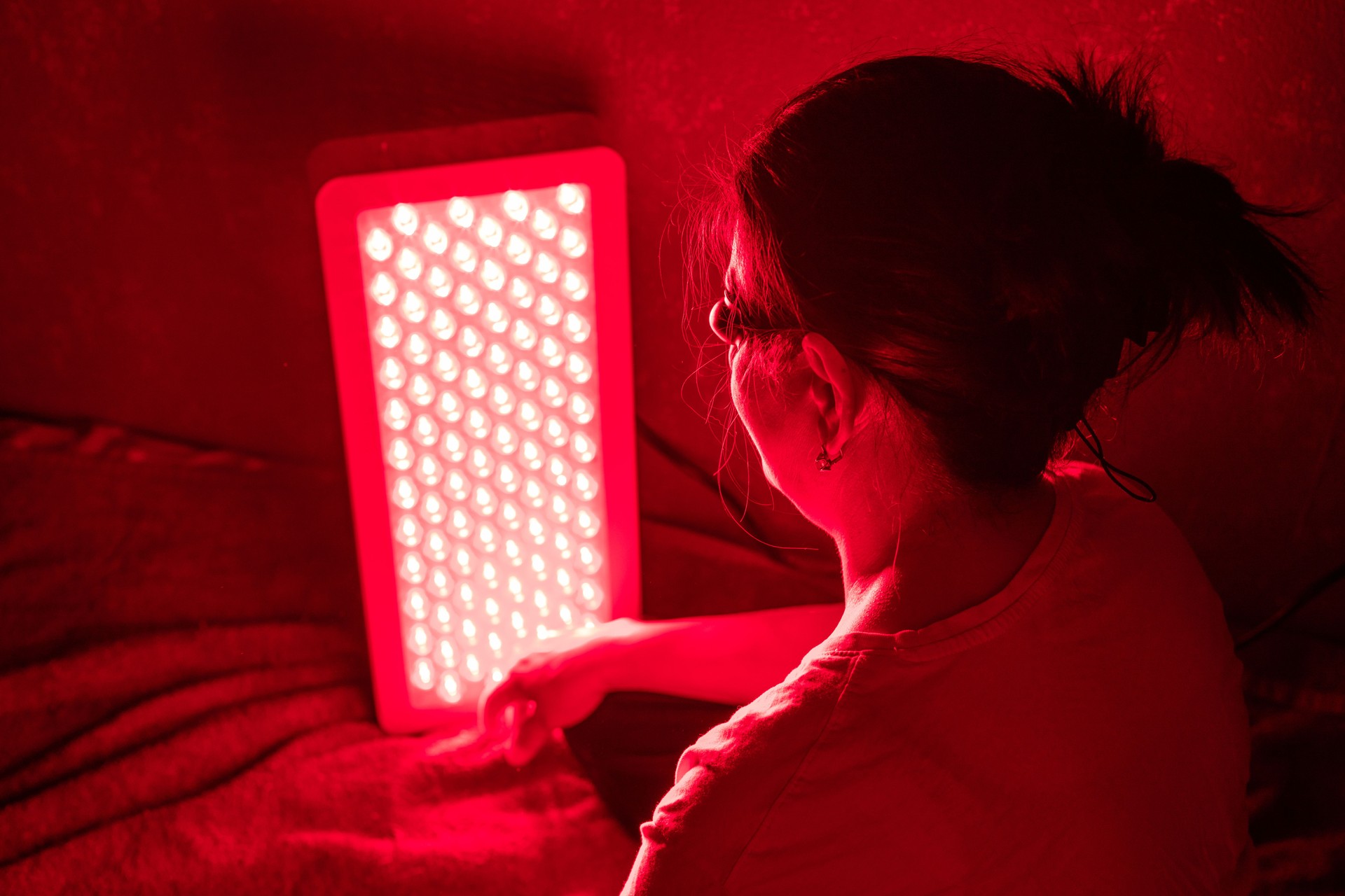 Woman doing Red Light Therapy Session with Panel