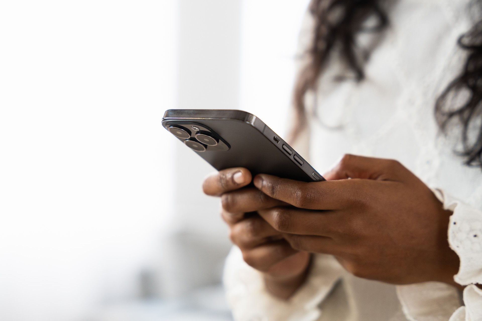 Close up of hands using phone for messaging via Spruce Health Apppp