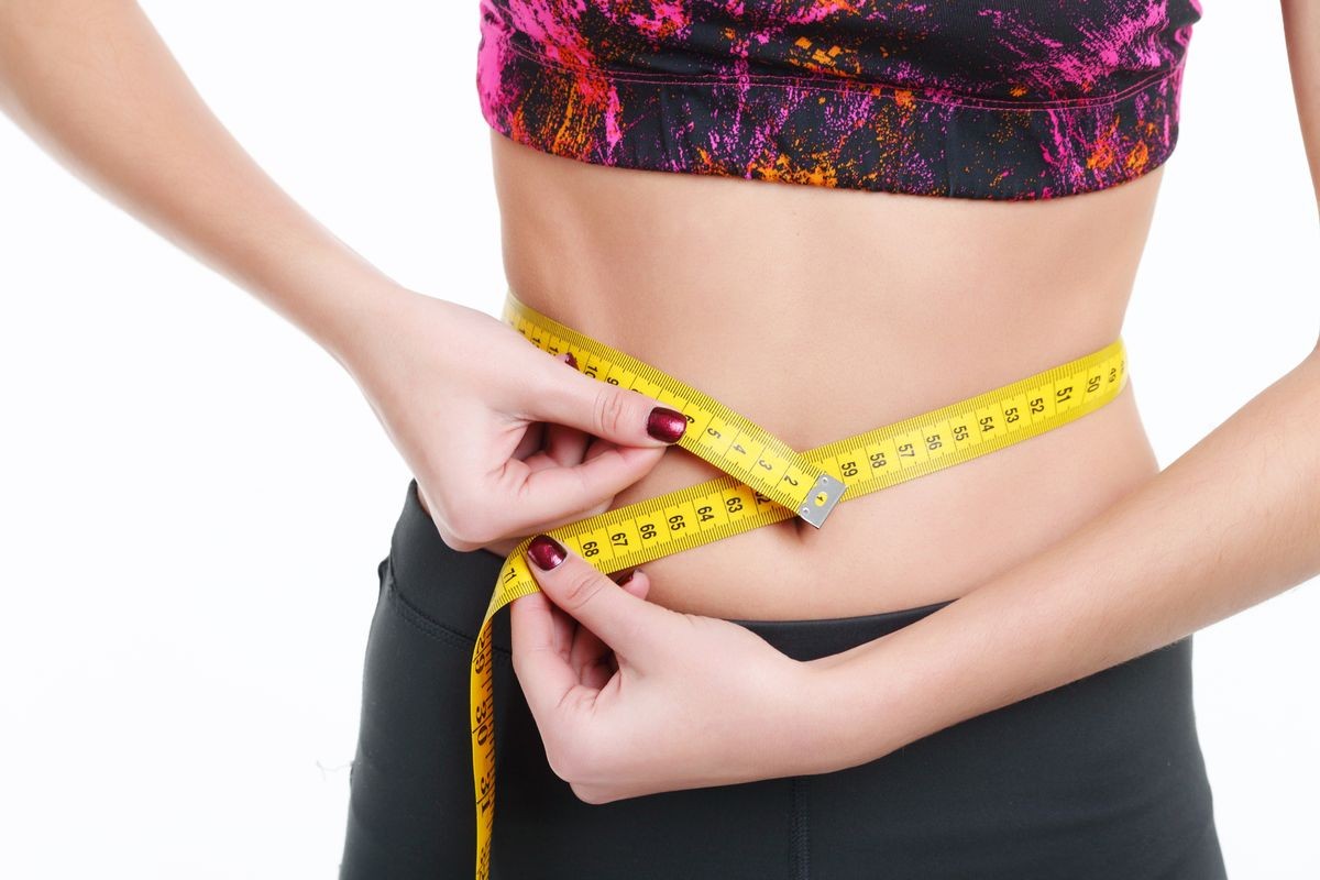 Woman measuring her body - medical weight loss concepts