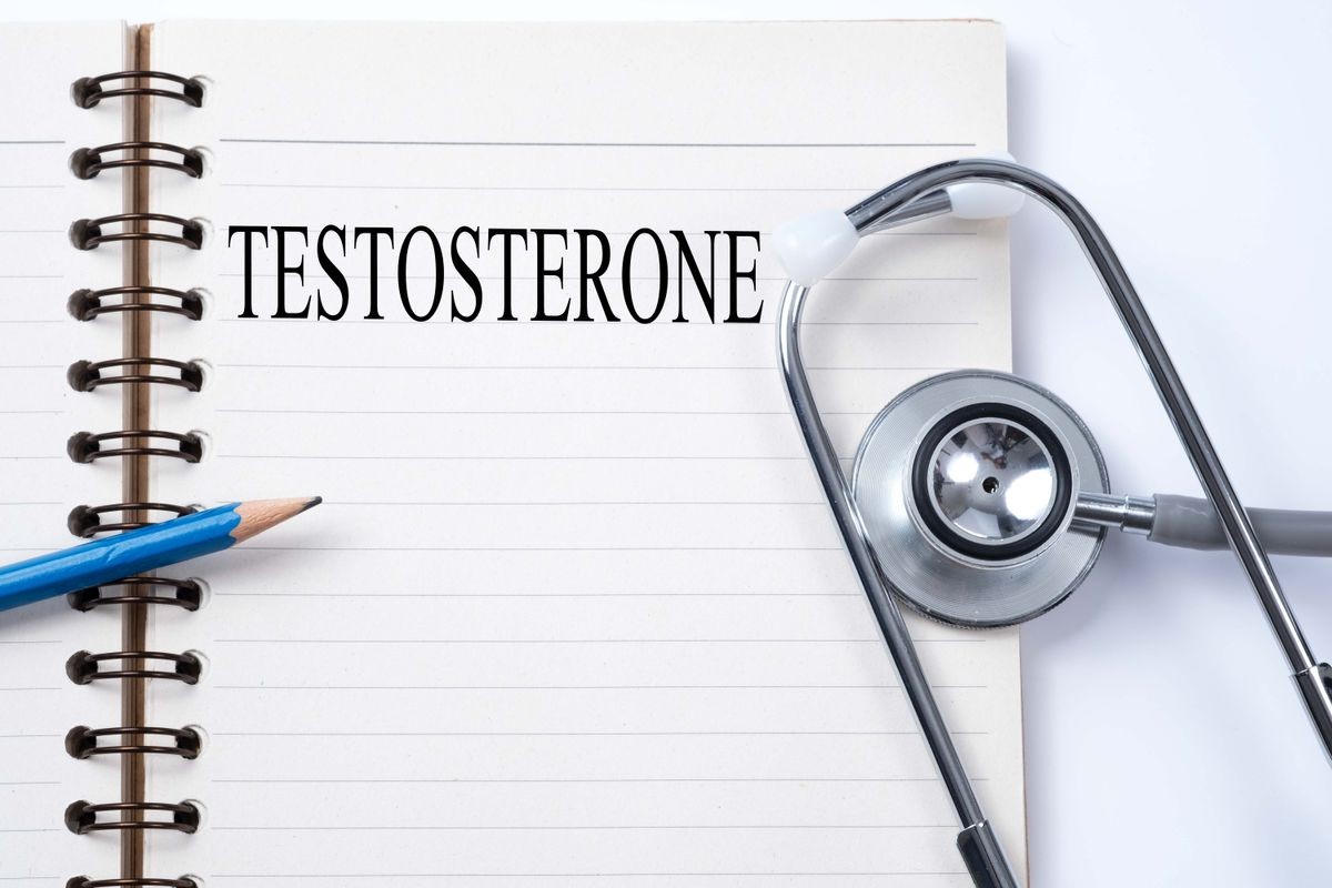 Stethoscope on notebook and pencil with TESTOSTERONE words as medical concept.